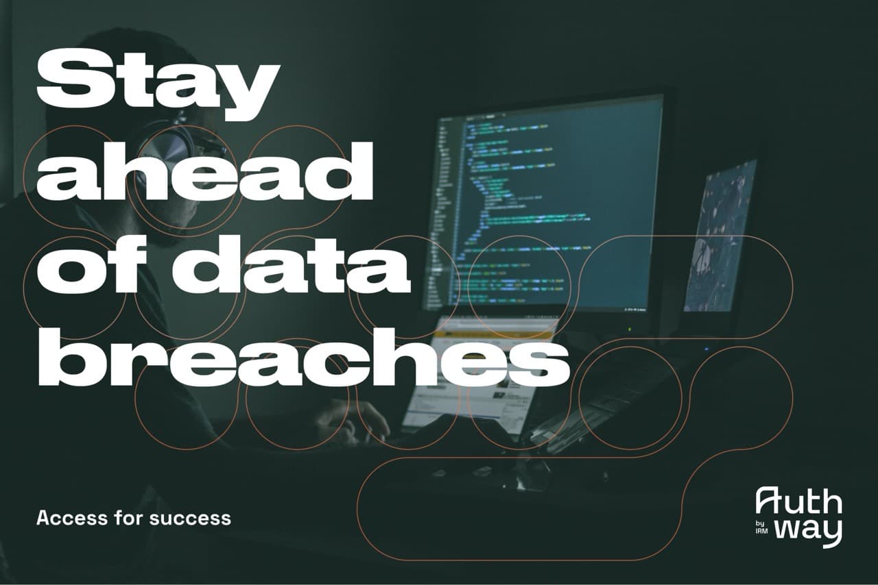 An image of a person at the computer in a dark room.